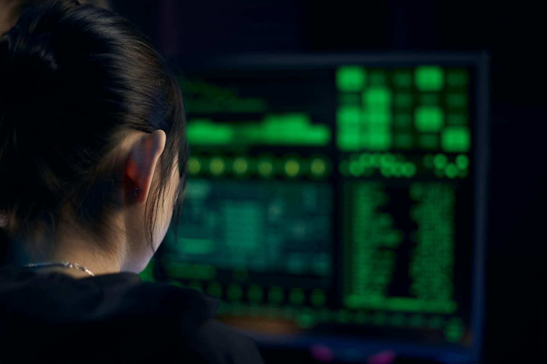 Security analyst monitoring screens in operations center
